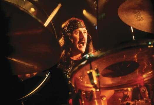 LIKE FATHER, LIKE SON: John Bonham (above) keeps the beat in this scene from Led Zeppelin’s motion picture “The Song Remains The Same.” His son, Jason, has made a name for himself as a drummer, too. Jason will use his father’s drumming on “When The Levee Breaks” as a backing track and profile his own fills and flourishes in concerts for the upcoming “Jason Bonham’s Led-Zeppelin Experience.” Photo courtesy Rhino/Warner Bros. Entertainment Inc.