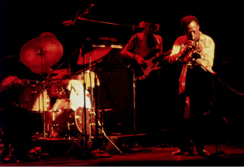 Miles Davis live. Left to right, drummer Jack DeJohnette, bassist Dave Holland, and Miles. Photo by Sandy Speiser