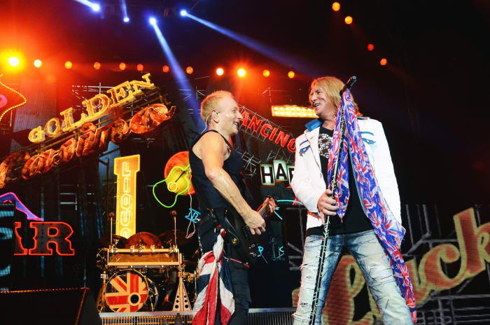 Def Leppard's Phil Collen (left) and Joe Elliott exchange smiles during the band's set on Aug. 3. (Photo by Chris M. Junior)