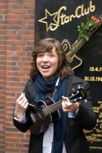 TOUR GUIDE, Stefanie Hempel performs a Beatles-ish version of “Twist and Shout” near the Star-Club marker in Hamburg, Germany. PHOTO BY CHRIS M. JUNIOR