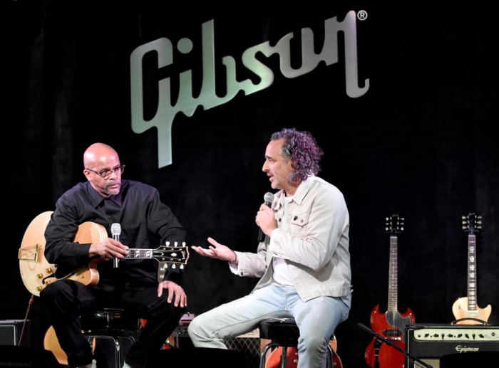 Gibson Brands CEO James Curleigh (right) speaks with Charles Berry Jr., who’s holding the company’s new Chuck Berry 1955 ES 350T model guitar. (Photo by Chris M. Junior)