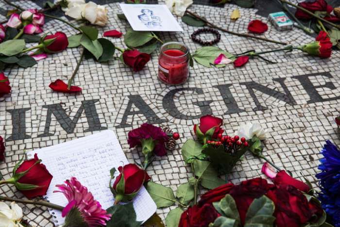NEW YORK, NY - DECEMBER 08: Memorabilia sits a top the "Strawberry Fields" tile mosaic in Central Park, which was created in tribute to the late musician John Lennon, to mark the anniversary of his death on December 8, in New York City. Lennon was shot and killed by a gunman outside his apartment in the nearby Dakota building. (Photo by Andrew Burton/Getty Images)
