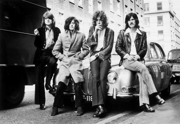 Led Zeppelin’s first photo session with WEA Records posed on a Jaguar car in a London street in December 1968. Photo by Dick Barnatt/Redferns
