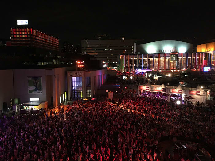 Typical crowd watching music on an outdoor stage at night during the Montreal Jazz Festival. Photo taken by Alisa B. Cherry