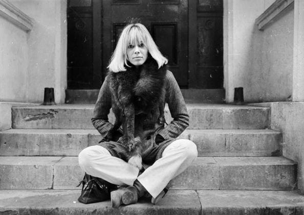 24th October 1968: Italian-born German actress Anita Pallenberg sits cross-legged on a flight of stone steps. (Photo by Larry Ellis/Express/Getty Images)