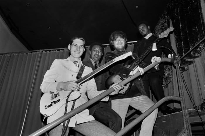 Booker T. & The M.G.’s, from left to right, Steve Cropper (guitar), Al Jackson Jr. (drums), Donald “Duck” Dunn (bass) and Booker T. Jones pose for a photo on their way to perform in the Stax Records Christmas Concert at the Mid-South Coliseum on December 20, 1968 in Memphis, Tennessee. Don Paulsen/Michael Ochs Archives/Getty Images.