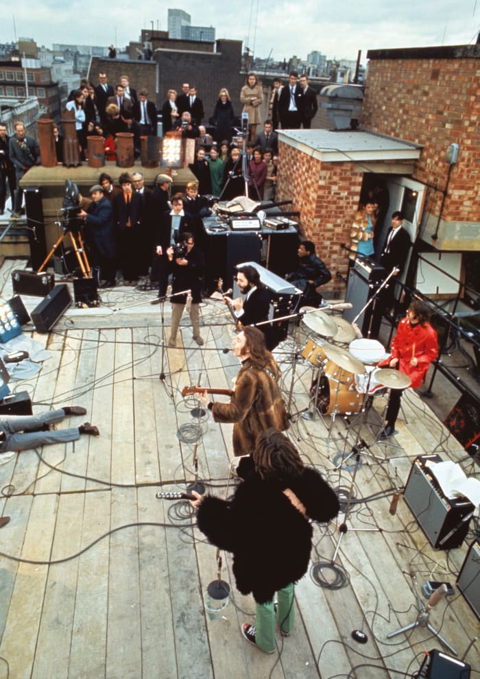 The Beatles perform on the roof of their offices at Savile Row, London, 30th January 1969. Photo by Ethan A. Russell/©Apple Corps Ltd.