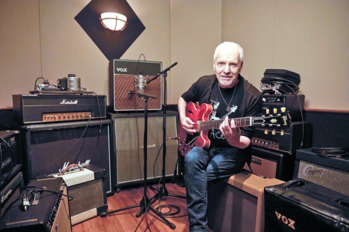 Peter Frampton, present day, enjoying the art of writing songs on guitar at his home studio. Publicity photo.