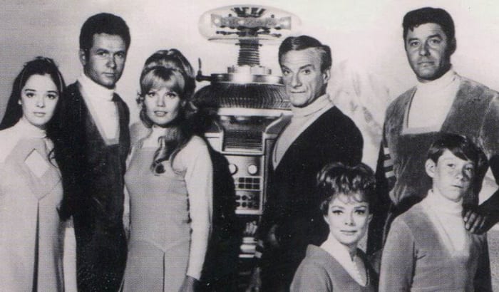 Lost in Space 1967 promotional photo (L-R) showing cast members: Angela Cartwright, Mark Goddard, Marta Kristen, Bob May (Robot), Jonathan Harris, June Lockhart, Guy Williams and Billy Mumy.