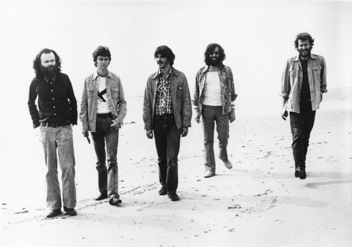 The Band poses for a portrait on the beach at the beginning of the '70s (L-R): Garth Hudson, Robbie Robertson, Rick Danko, Richard Manuel and Levon Helm. Michael Ochs Archives/Getty Images.