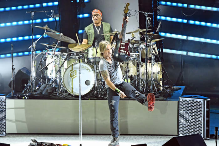 Keith Urban holds up one of the many guitars he played during his July 29 show at the PNC Bank Arts Center in Holmdel, New Jersey. (Photo by Chris M. Junior)