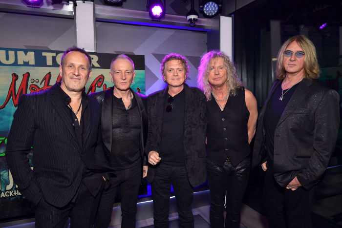 Def Leppard (L-R, Vivian Campbell, Phil Collen, Rick Allen, Rick Savage, and Joe Elliott) speak during the press conference for THE STADIUM TOUR DEF LEPPARD - MOTLEY CRUE - POISON at SiriusXM Studios in Los Angeles, California. (Photo by Emma McIntyre/Getty Images for SiriusXM)