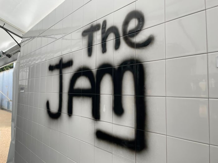 The spray-painted Jam wall patterned after the one used on the cover of The Jam’s 1977 debut album In The City. Many fans at the exhibition posed for photos by the wall. (Photo by John Curley)