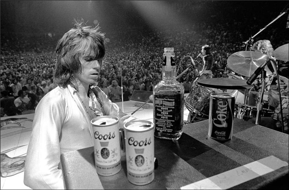 Rolling Stones guitarist Keith Richards assesses the choices at a makeshift onstage bar during the band's 1972 U.S. tour. The moment was captured by Ethan Russell. Photo courtesy Morrison Hotel gallery.