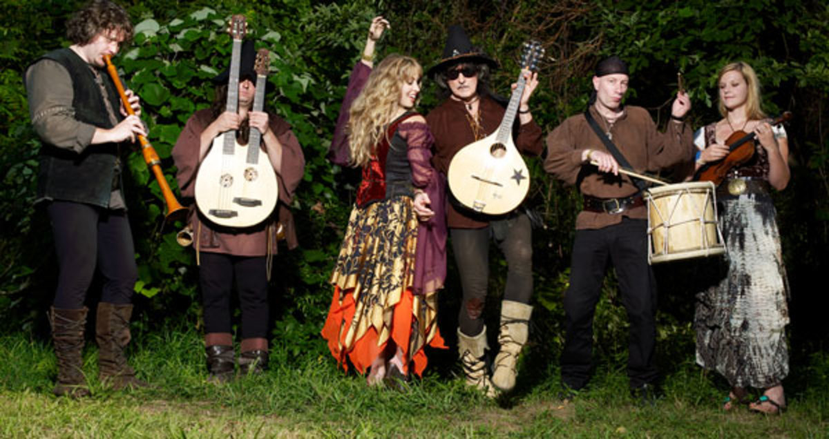 Blackmore's Night features Deep Purple guitarist Ritchie Blackmore (dancing, center) and his wife, Candice Night (center, dancing). Publicity photo.