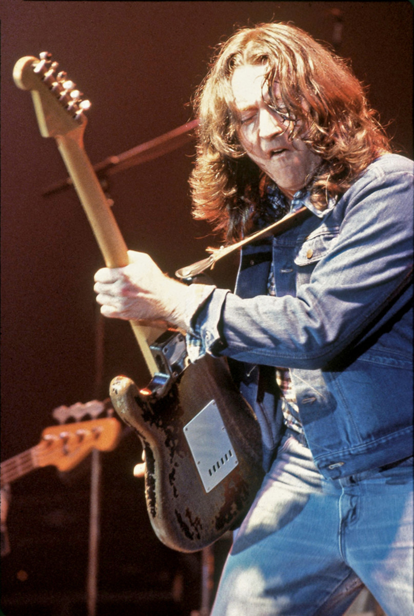 Rory Gallagher playing guitar