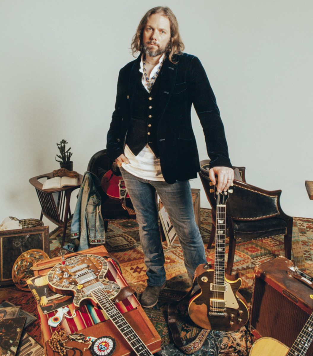  Rich Robinson poses with some of his favorite guitars. Photo by Alysse Gafkjen.