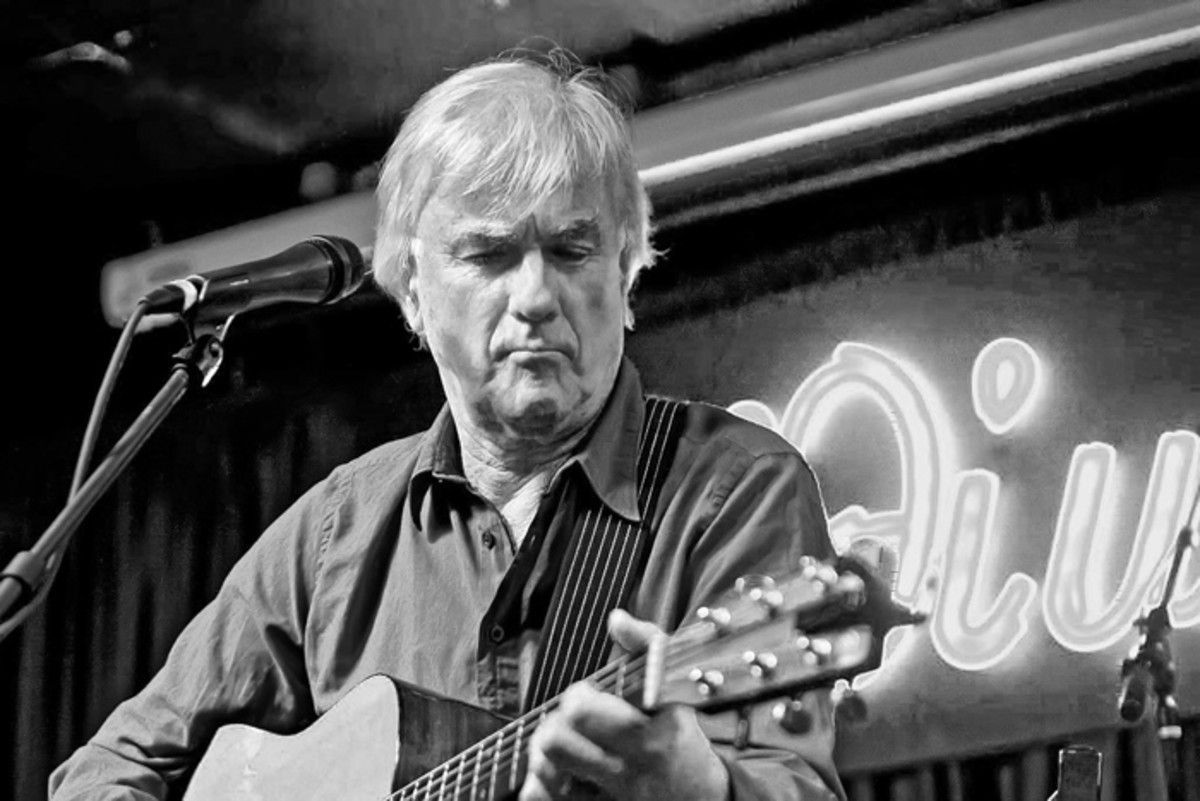 Jim McCarty of The Yardbirds playing acoustic guitar at the Iridium Jazz Club in 2012. Photo by Arnie Goodman.