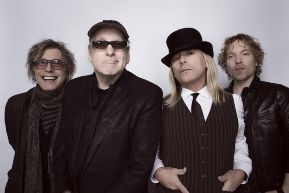 CURRENT TRICK (L-R): Tom Petersson, Rick Nielsen, Robin Zander, Daxx Nielsen and their newest album, “We’re All Alright!” Photo by David McClister.