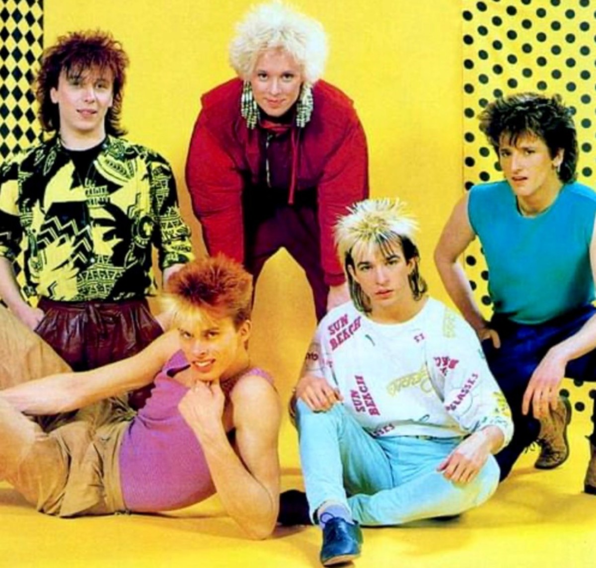 Kajagoogoo publicity photo, 1983, Limahl seated in a white shirt, courtesy Facebook-Limahl Official