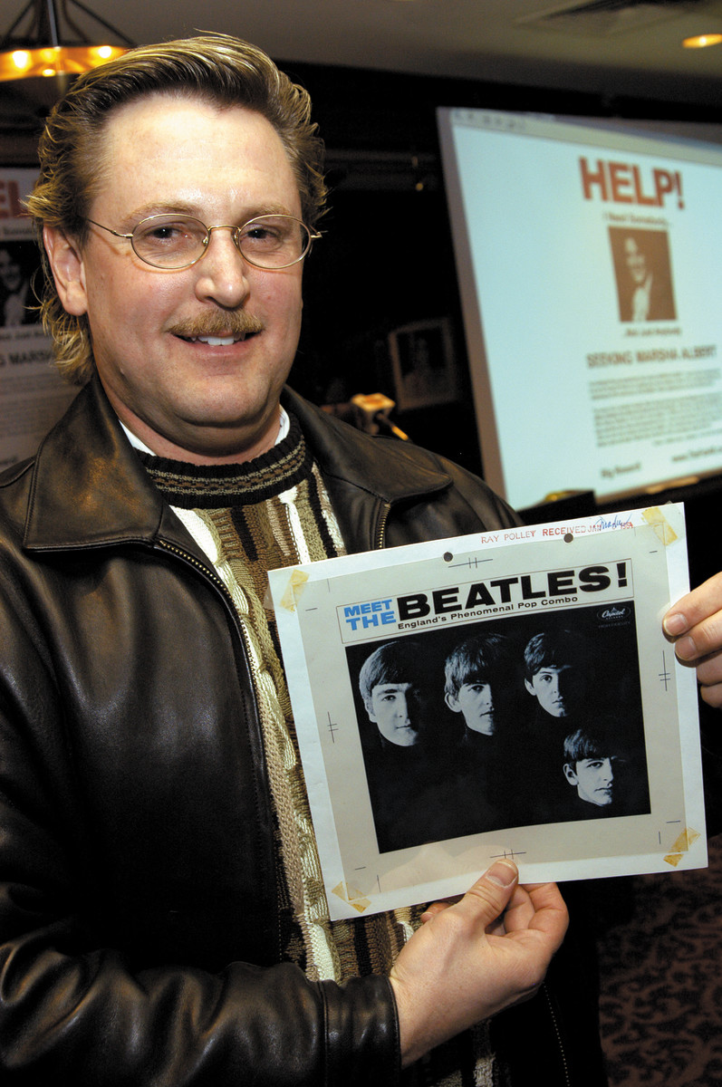Beatles collector and owner of Beatles4Me.com, Gary Hein, holding the original cover art for The Beatles albumundefinedMeet The Beatles. Photo: Wire Images.